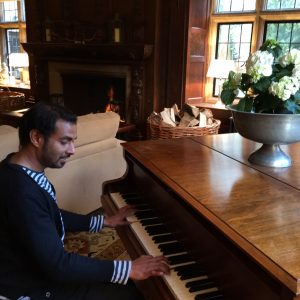 Playing piano at a student home.