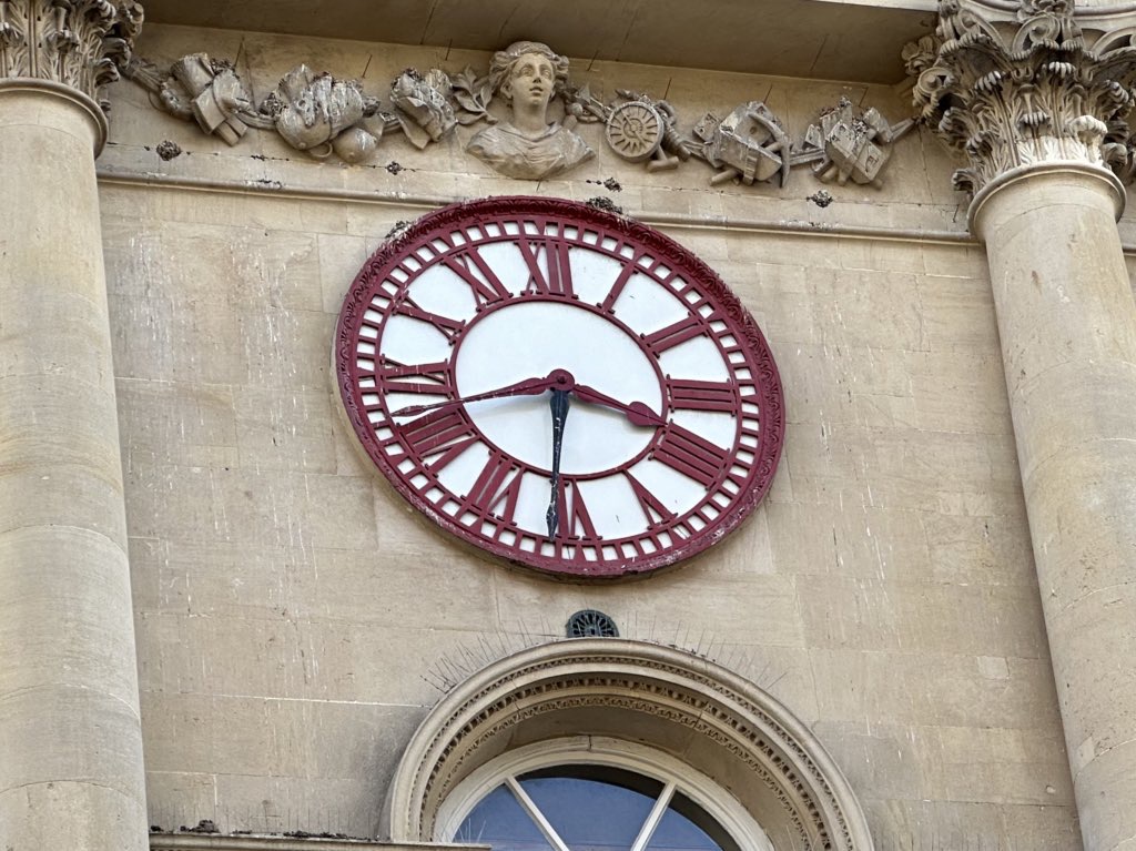 Alt text: Clock on the Bristol Corn Exchange showing both Bristol Time and London Time — a historic symbol of Britain’s transition to standardised railway time in the 19th century.